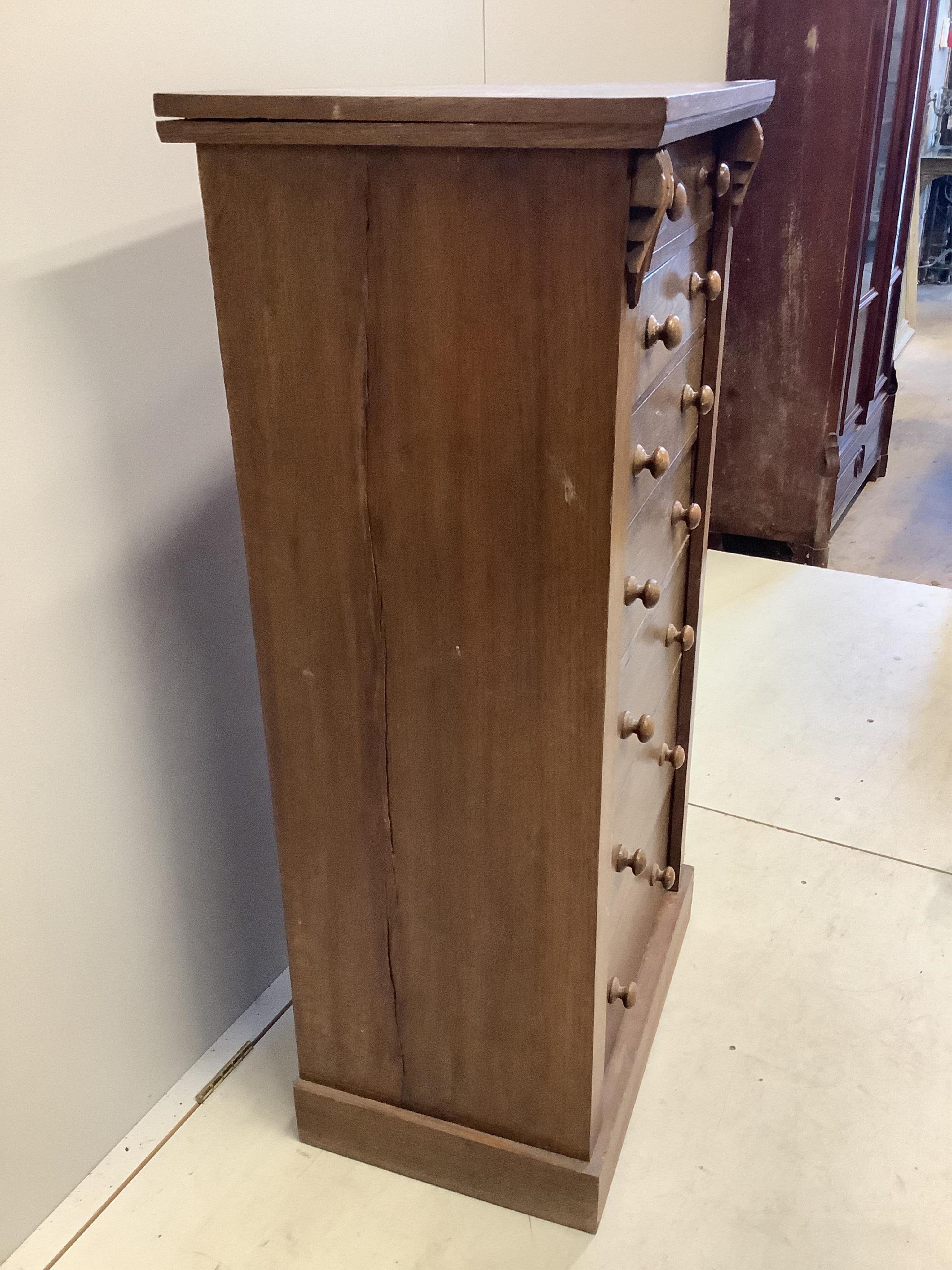 A Victorian style oak Wellington chest, width 60cm, depth 42cm, height 120cm. Condition - fair, top has a horizontal split, plinth foot scuffed and worn.